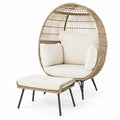 Fauteuil en rotin avec repose-pieds et coussins crème