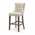Tabouret de bar en bois avec assise en lin beige et clous décoratifs
